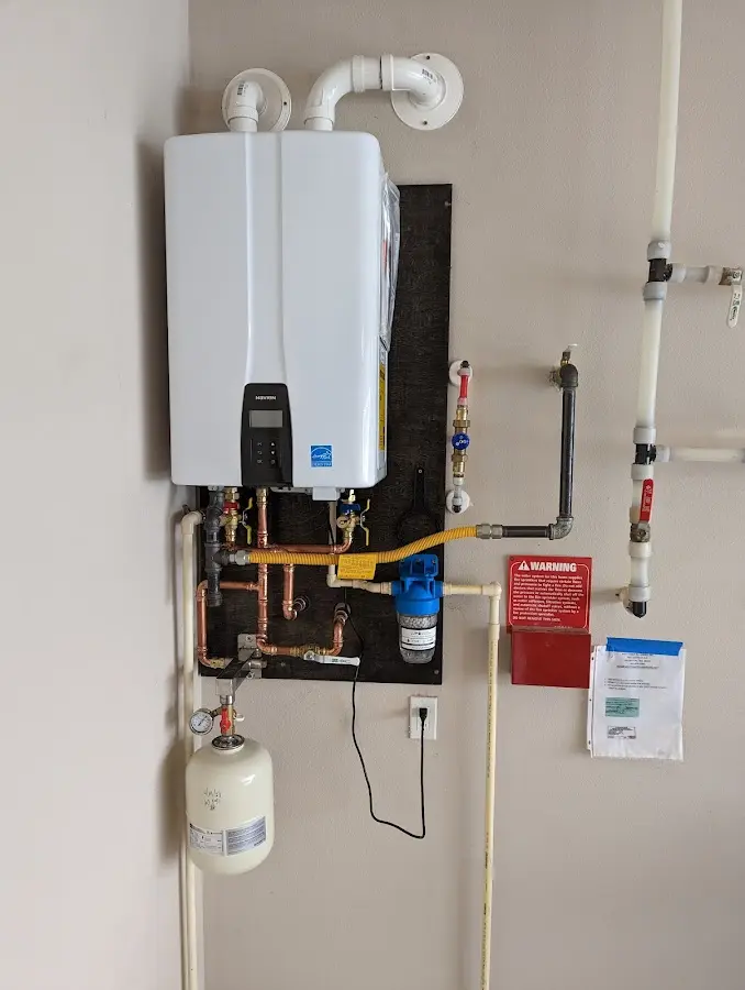 Professional plumber installing copper piping in a Haring home